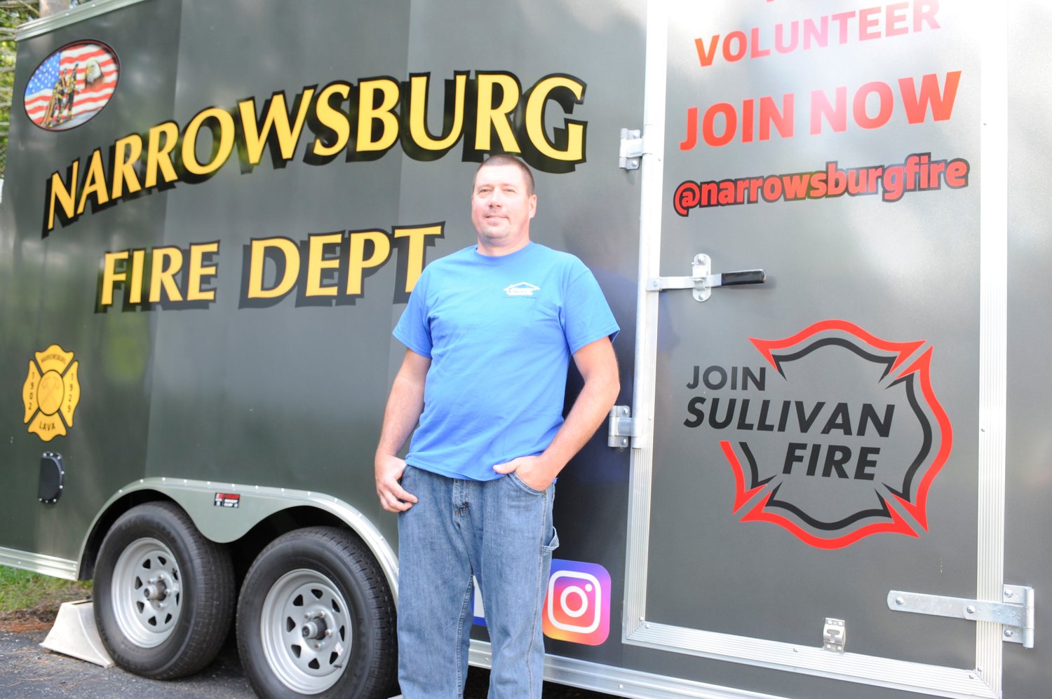 David Casey, chief of the Narrowsburg Fire Department, stands by the department’s enclosed trailer, near a reminder of the Join Sullivan Fire message.